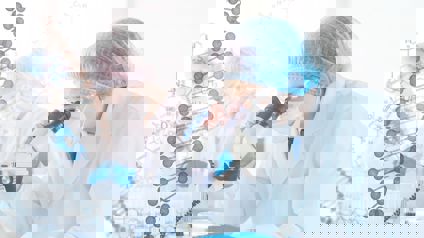 Scientist Analysing Sample Under Microscope