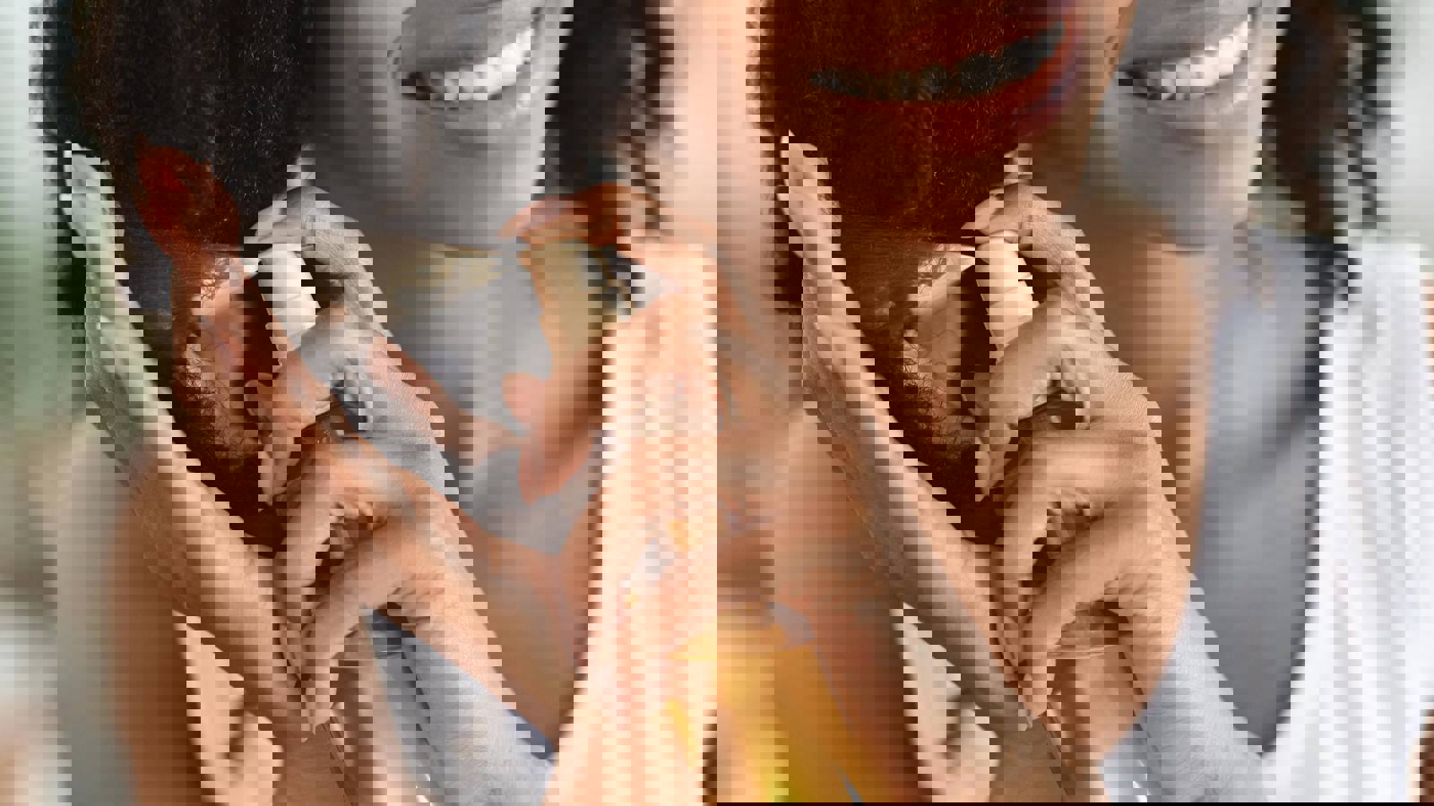 young black lady spraying hair care product on her hair