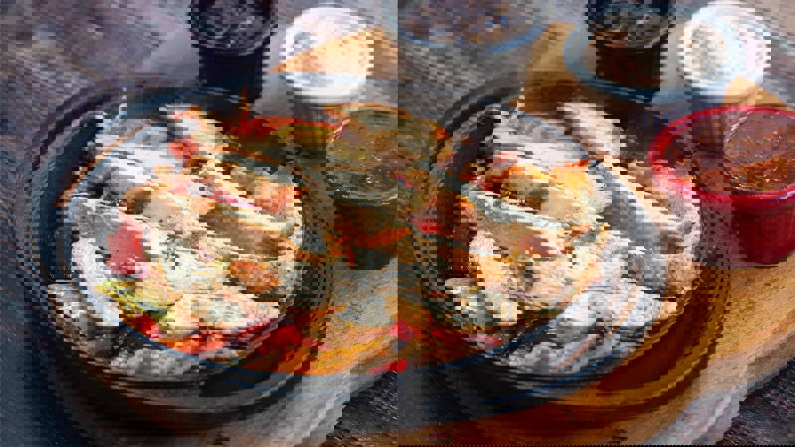 Plate of sliced chicken strips and three sauces