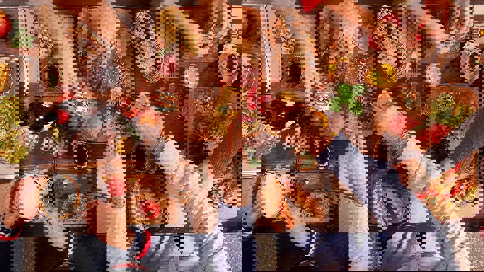 Hands reaching over table sharing snacks