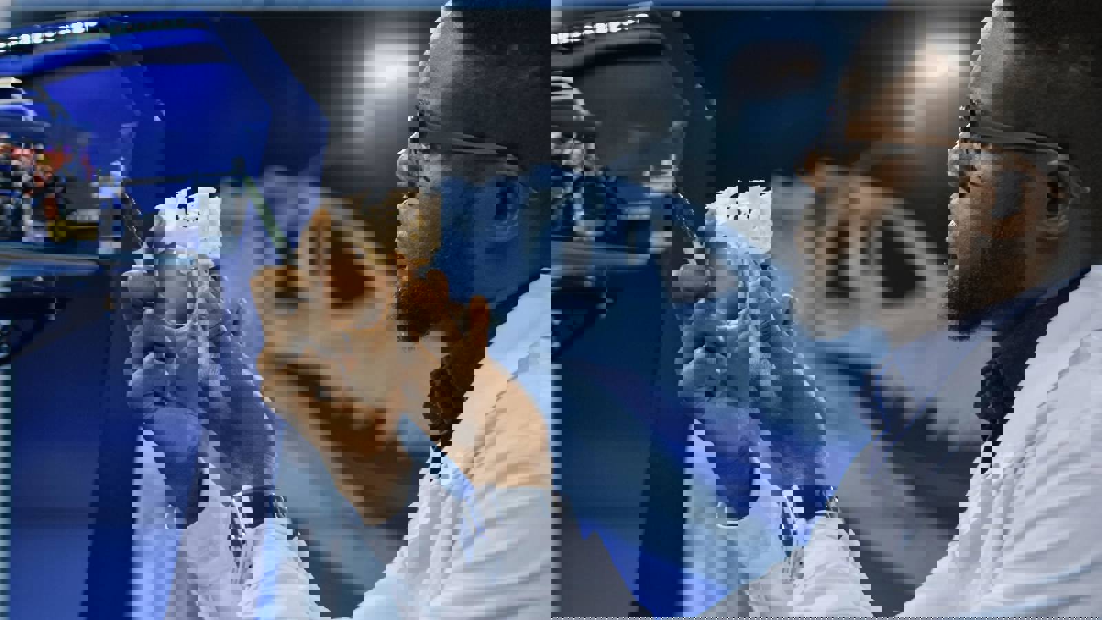 Young black scientist examining 3D printed medical component