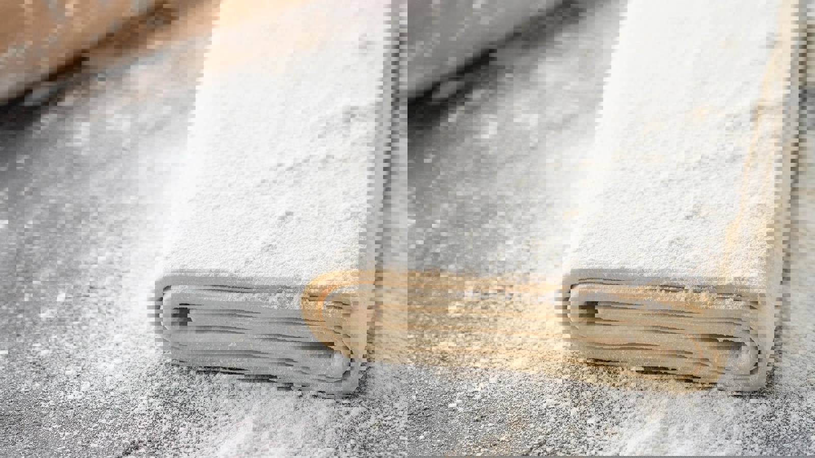 Raw puff pastry on floured surface