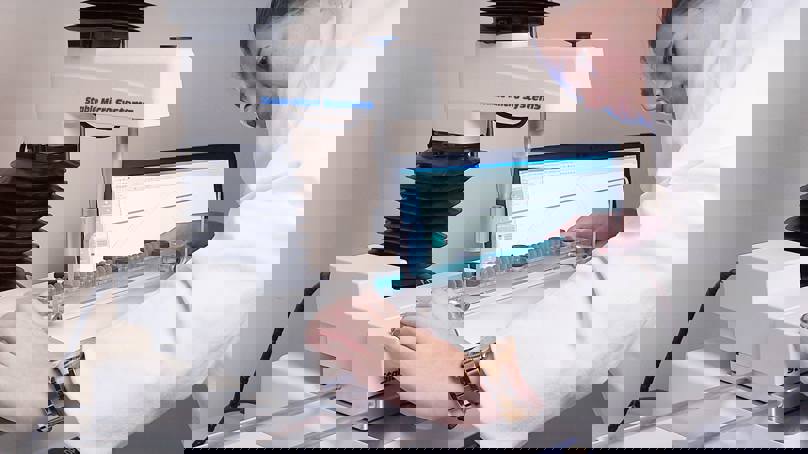 Woman In White Coat Preparing A Test On A Texture Analyser