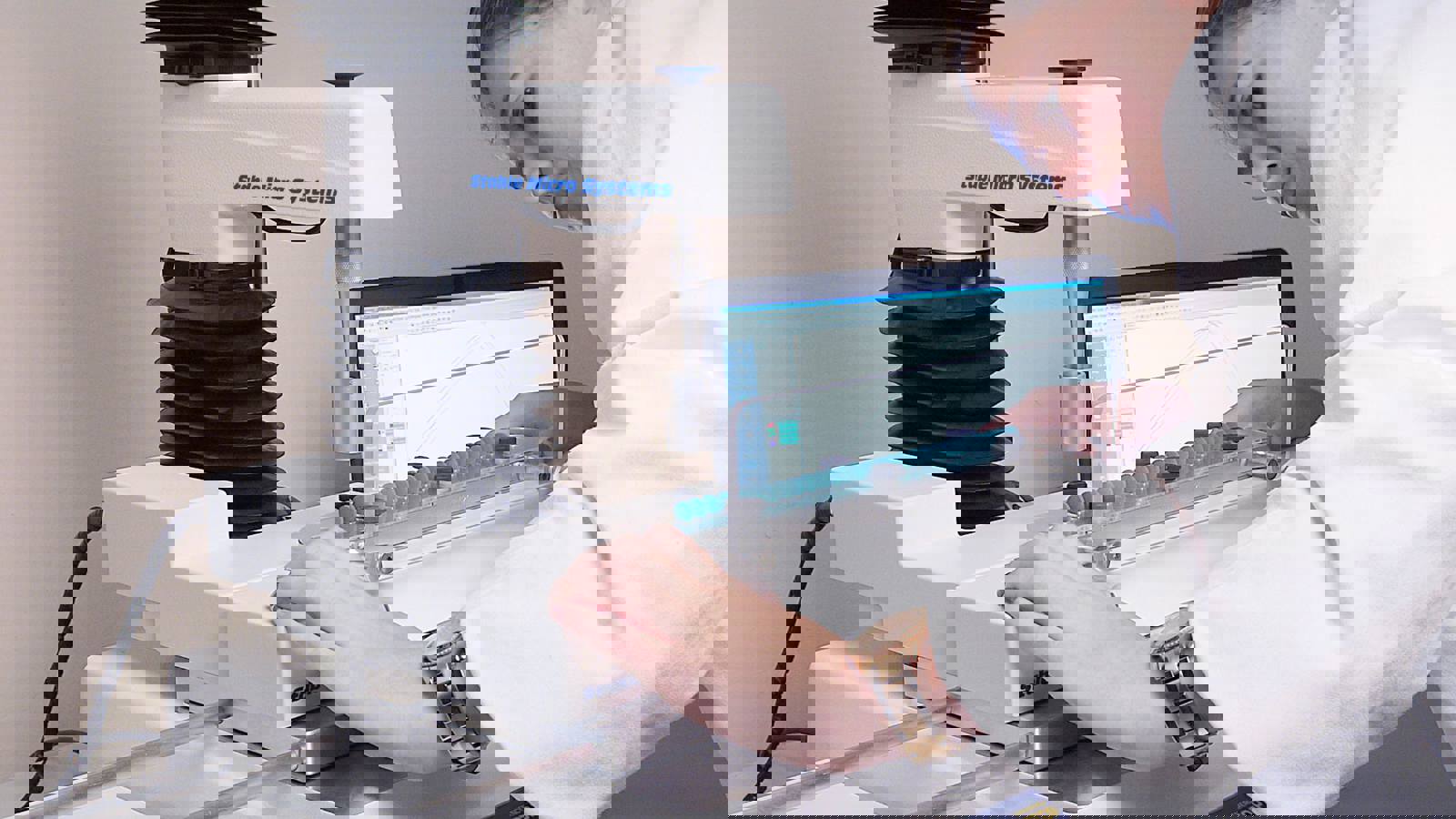 Woman in white coat preparing a test on a Texture Analyser