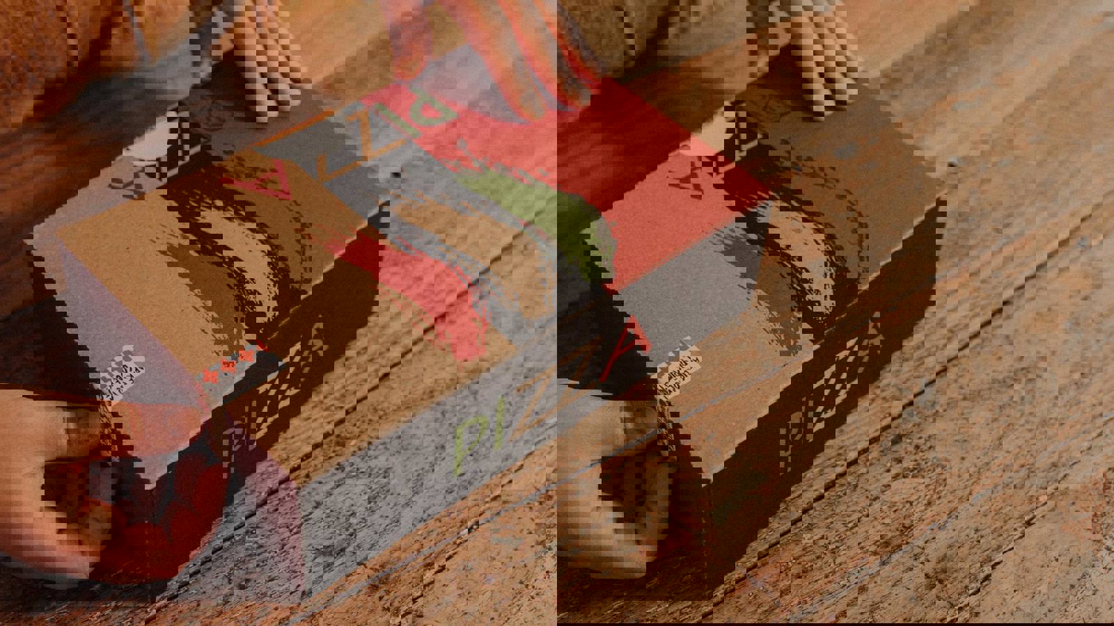 Hands opening cardboard pizza box